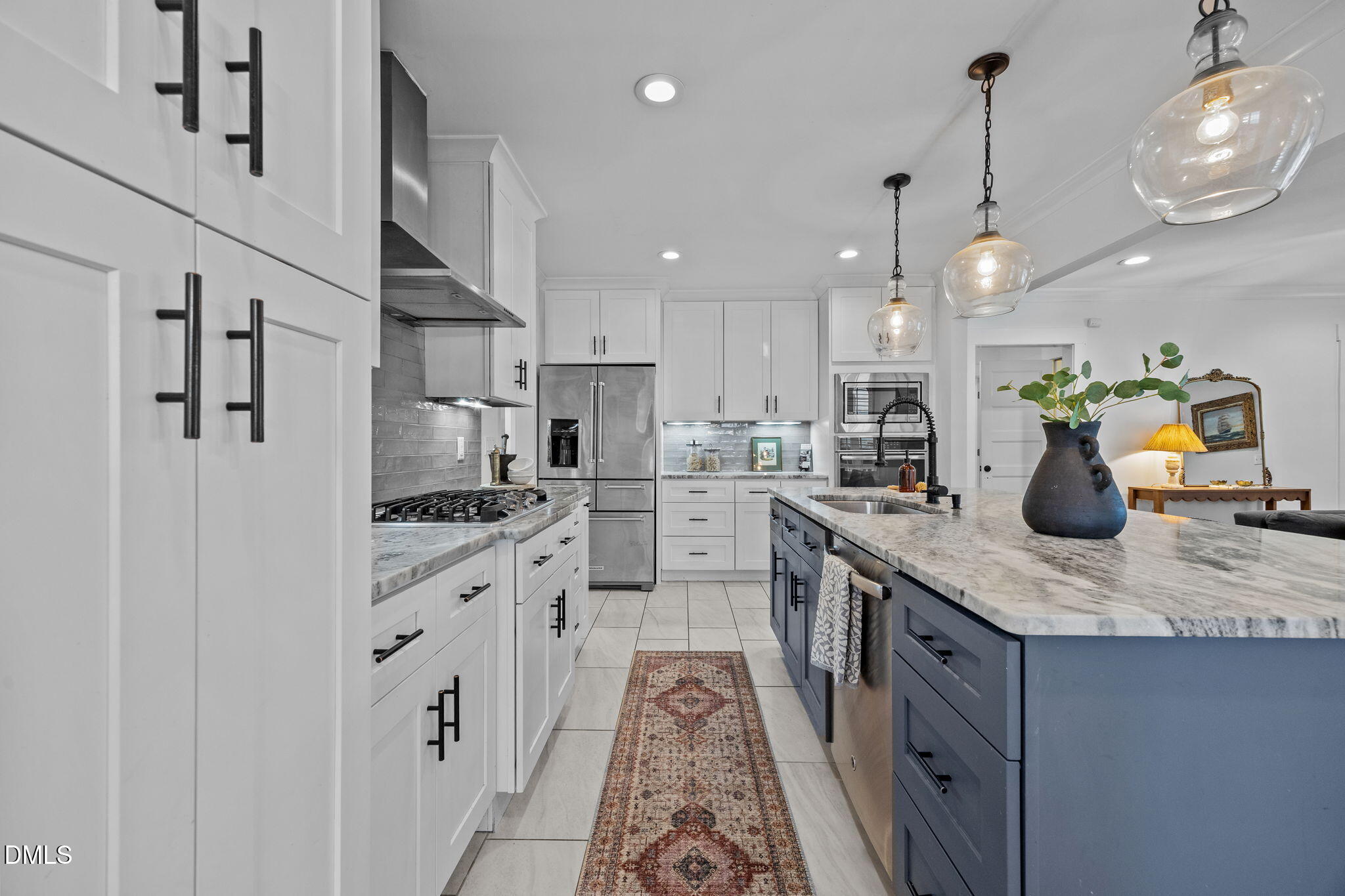 603 Frank Street Raleigh, NC 27604 - Photo 6 of 29 a kitchen with stainless steel appliances kitchen island granite countertop a sink stove and refrigerator