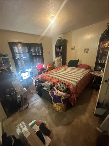 a bedroom with a bed and a mirror