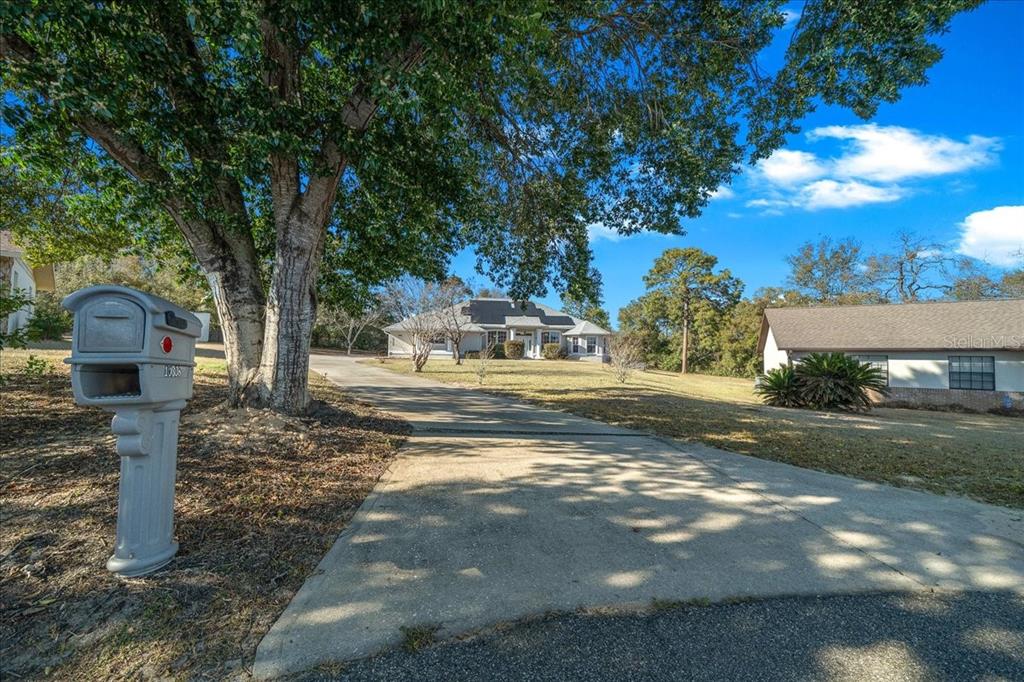 10308 Southwest 83rd Terrace Ocala, FL 34481 - Photo 17 of 75 a view of street with large trees