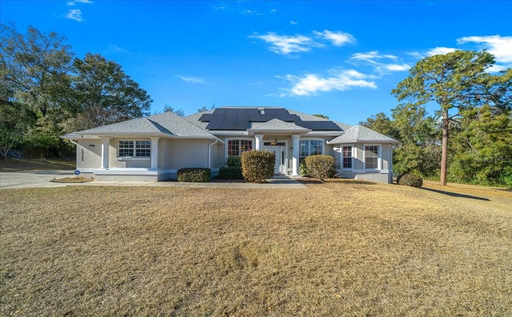 10308 Southwest 83rd Terrace Ocala, FL 34481 - Photo 20 of 75 a front view of a house with a garden