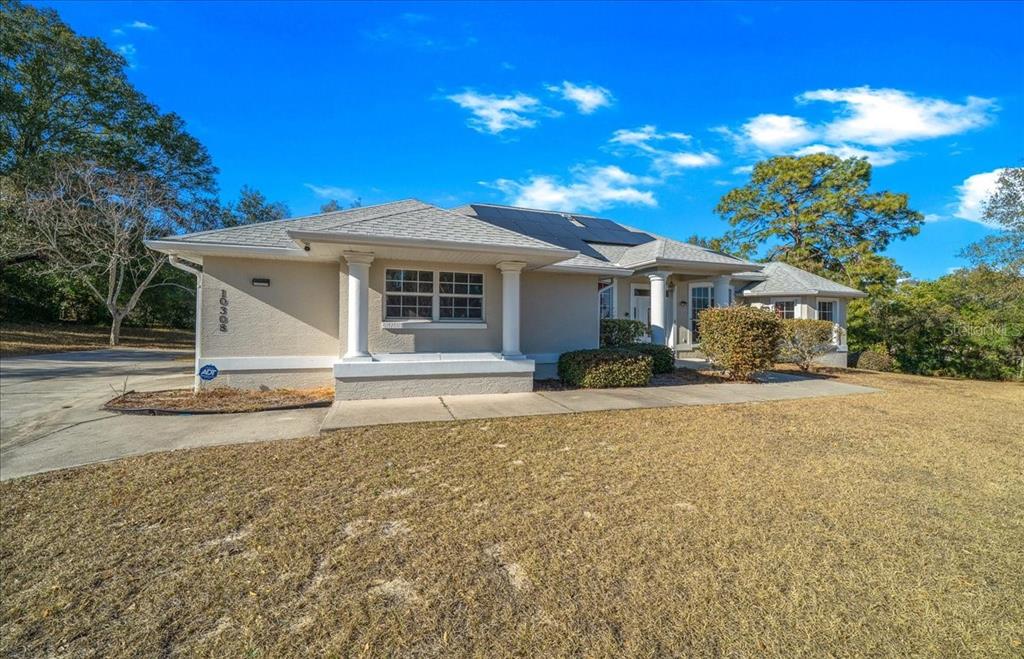 10308 Southwest 83rd Terrace Ocala, FL 34481 - Photo 23 of 75 a front view of a house with a yard