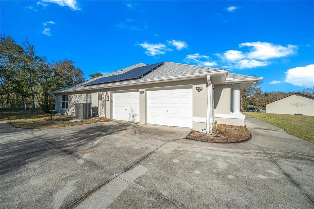 10308 Southwest 83rd Terrace Ocala, FL 34481 - Photo 25 of 75 a view of a house with a yard and garage