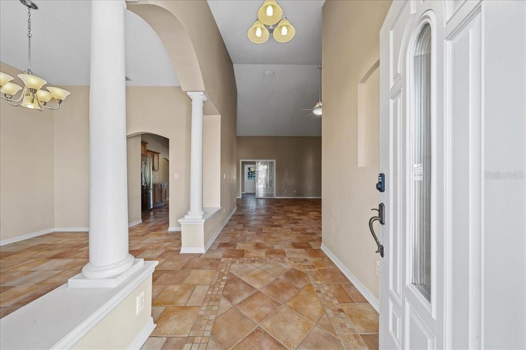 10308 Southwest 83rd Terrace Ocala, FL 34481 - Photo 32 of 75 a view of a hallway with wooden floor and a living room