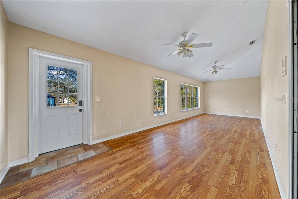 10308 Southwest 83rd Terrace Ocala, FL 34481 - Photo 43 of 75 wooden floor in an empty room with a window