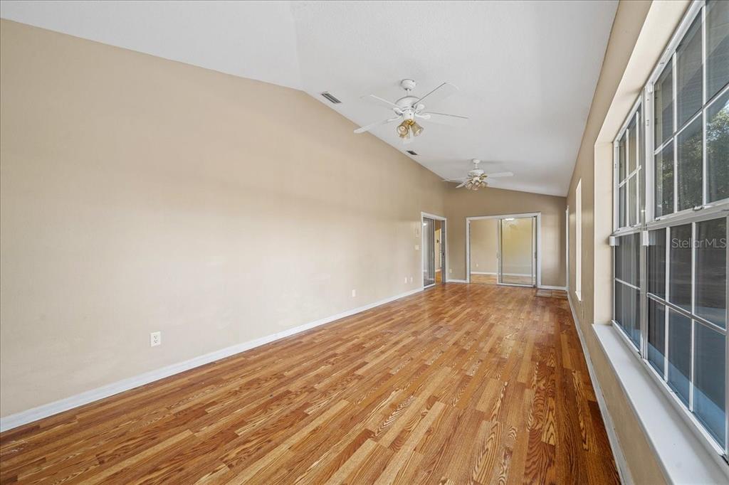 10308 Southwest 83rd Terrace Ocala, FL 34481 - Photo 45 of 75 a view of a room with wooden floor and staircase