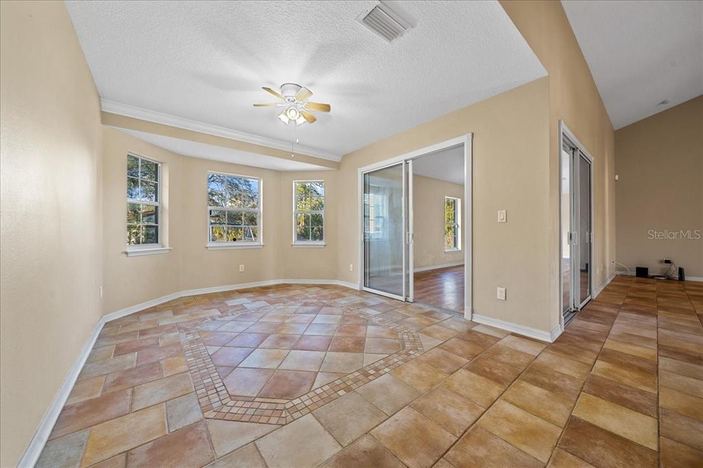 10308 Southwest 83rd Terrace Ocala, FL 34481 - Photo 48 of 75 a view of an empty room with window and chandelier