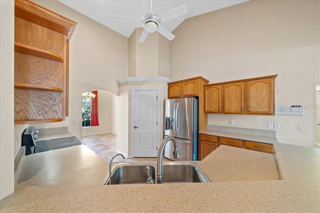 10308 Southwest 83rd Terrace Ocala, FL 34481 - Photo 50 of 75 a kitchen with stainless steel appliances granite countertop a sink and a refrigerator