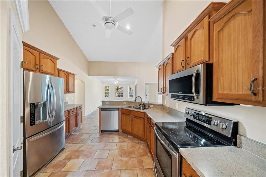 10308 Southwest 83rd Terrace Ocala, FL 34481 - Photo 51 of 75 a kitchen with stainless steel appliances granite countertop a stove refrigerator and microwave