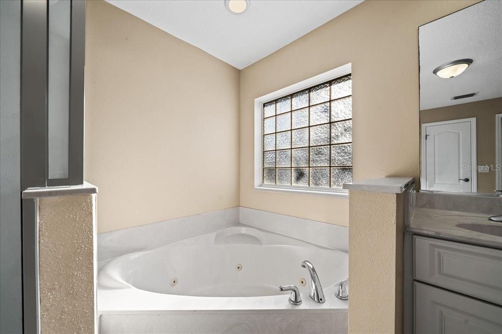 10308 Southwest 83rd Terrace Ocala, FL 34481 - Photo 58 of 75 a bathroom with a bathtub and a window