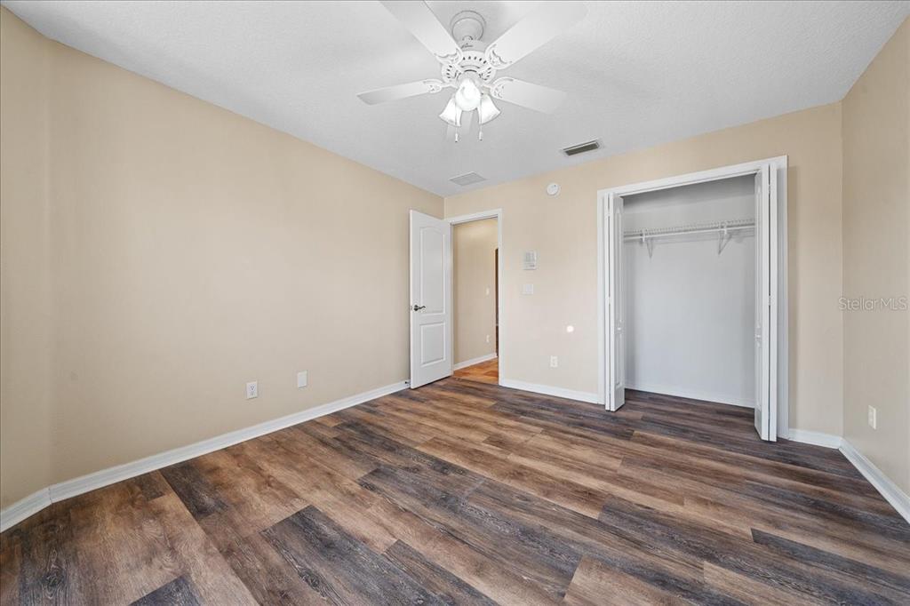 10308 Southwest 83rd Terrace Ocala, FL 34481 - Photo 66 of 75 a view of an empty room with window a ceiling fan and wooden floor