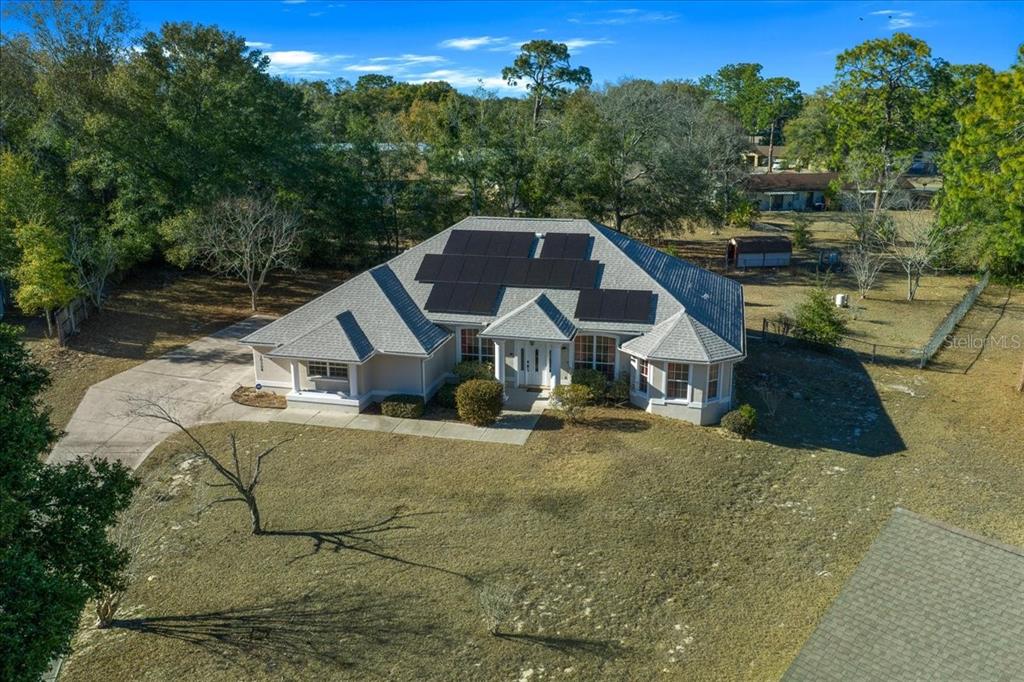 10308 Southwest 83rd Terrace Ocala, FL 34481 - Photo 7 of 75 an aerial view of a house with swimming pool and large trees