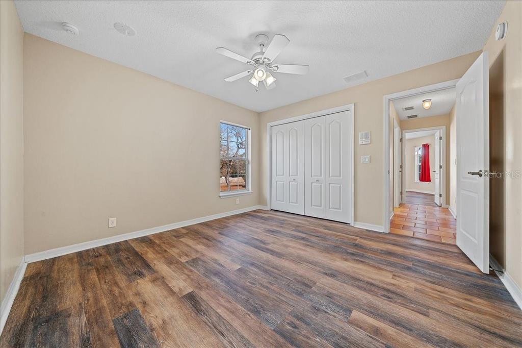 10308 Southwest 83rd Terrace Ocala, FL 34481 - Photo 71 of 75 wooden floor in an empty room with a window