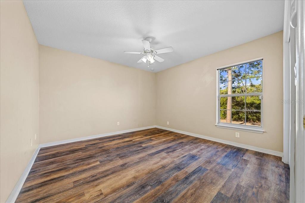 10308 Southwest 83rd Terrace Ocala, FL 34481 - Photo 72 of 75 an empty room with a window and a ceiling fan