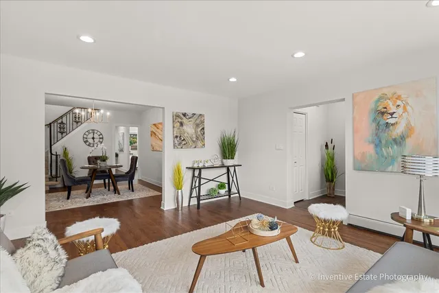 a living room with furniture and wooden floor