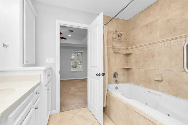 a bathroom with a bathtub and a shower