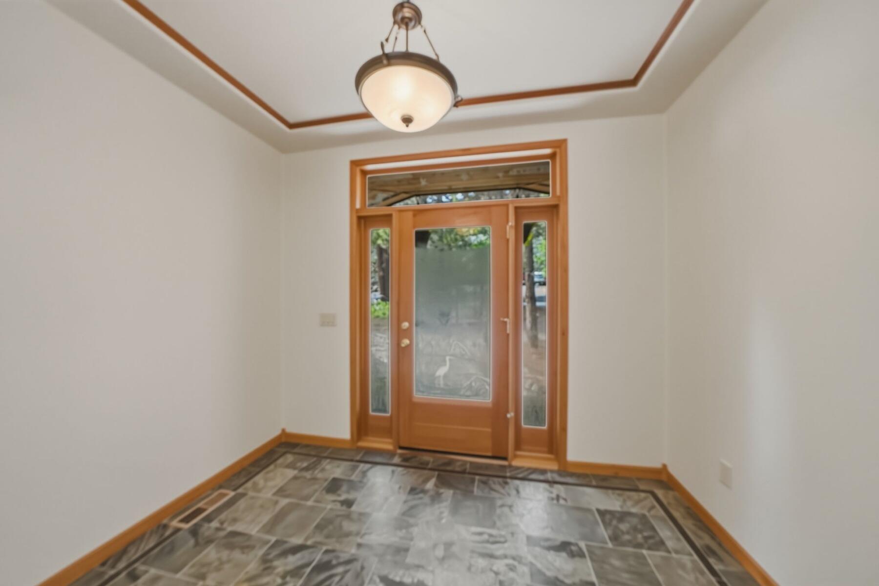 637 Northwest Silver Buckle Road Bend, OR 97703 - Photo 5 of 68 a view of an empty room with window and wooden floor