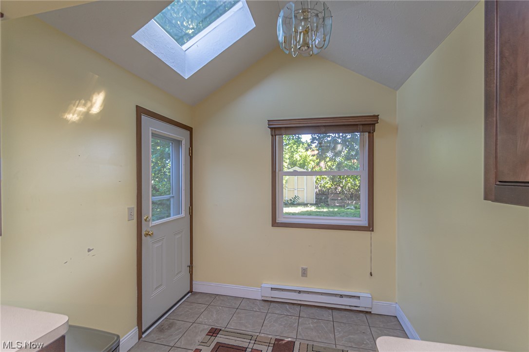 24307 Knickerbocker Road Bay Village, OH 44140 - Photo 10 of 14 Doorway with a baseboard heating unit, lofted ceiling with skylight, and light tile floors