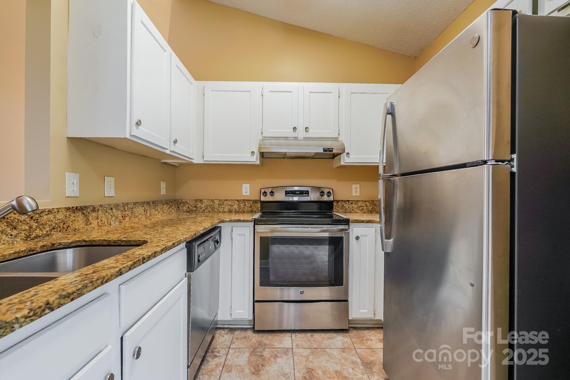 4110 Runaway Circle Monroe, NC 28110 - Photo 6 of 16 a kitchen with a refrigerator sink and cabinets
