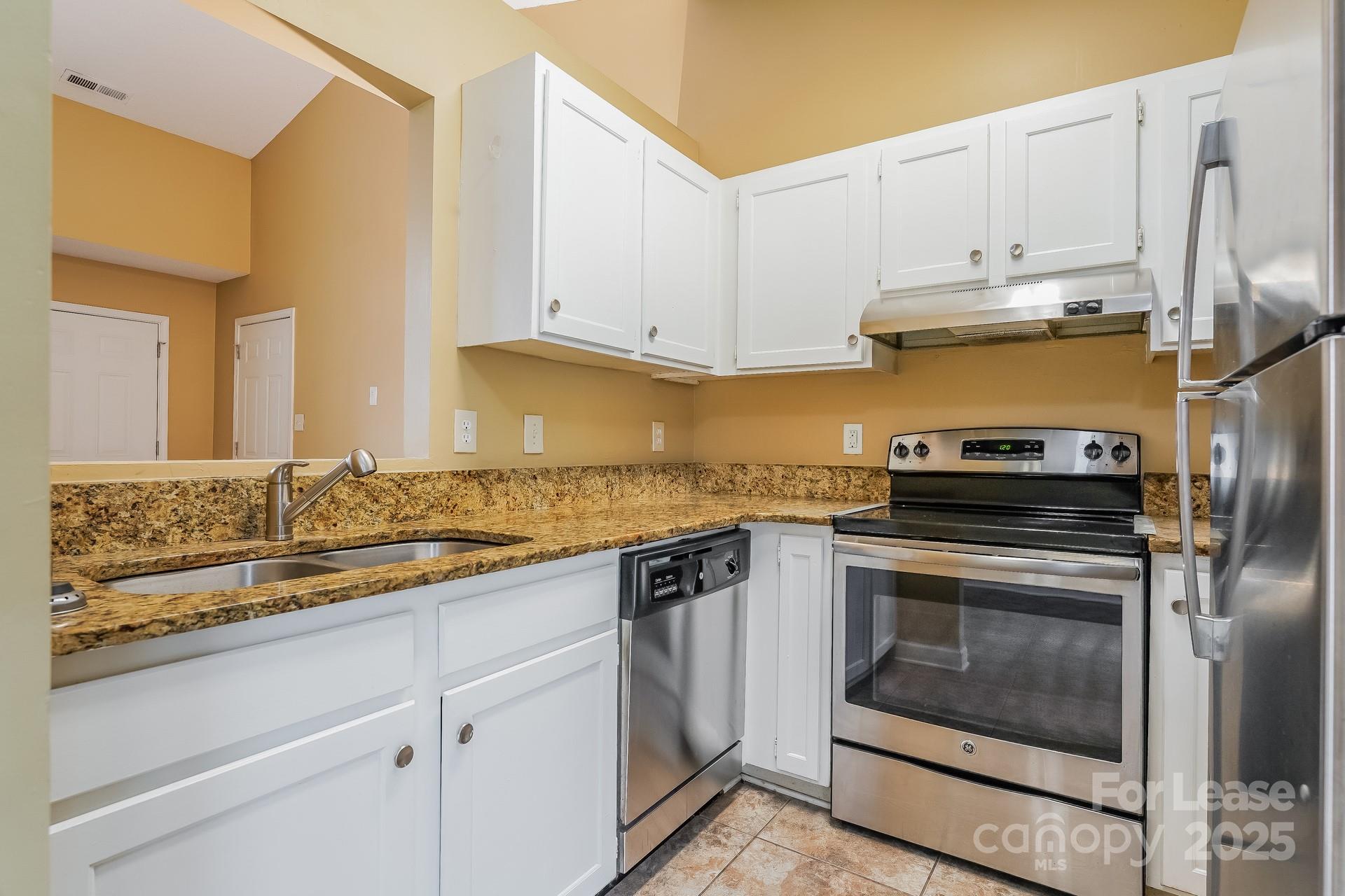 4110 Runaway Circle Monroe, NC 28110 - Photo 7 of 16 a kitchen with stainless steel appliances granite countertop a stove a sink and a microwave
