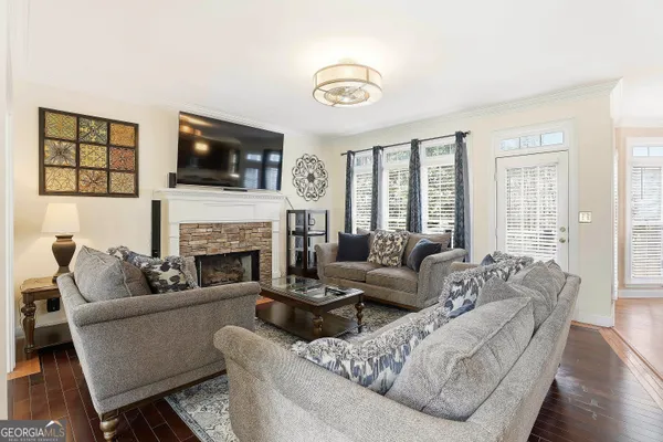 a living room with furniture fireplace and flat screen tv