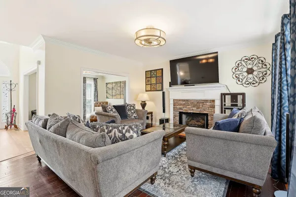 a living room with furniture a flat screen tv and a fireplace