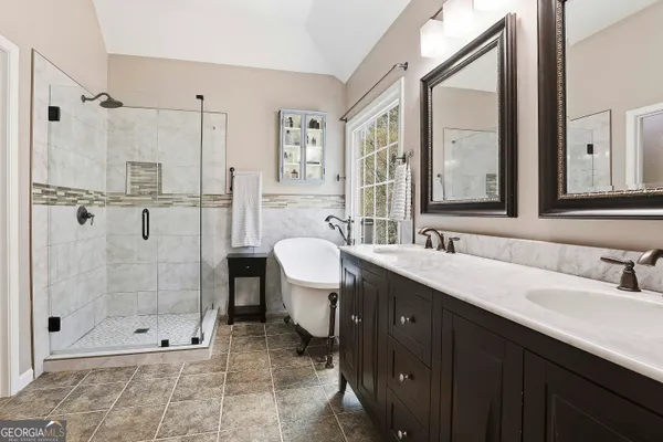 a bathroom with a shower sink and mirror