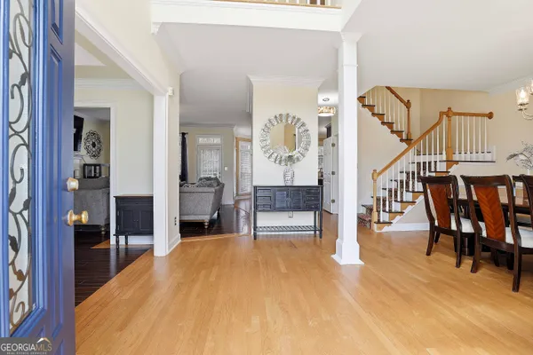 a view of a living room filled with furniture and stairs