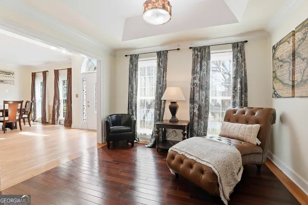 a bedroom with furniture and wooden floor