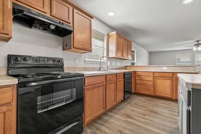 a kitchen with stainless steel appliances granite countertop a stove and a sink
