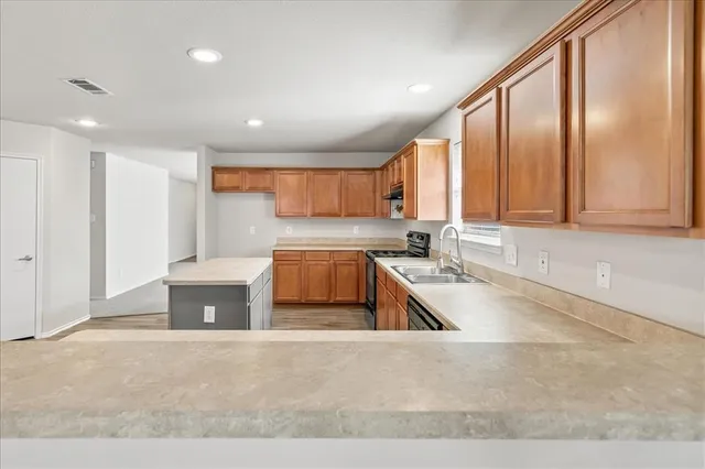 a view of a kitchen with a sink and cabinets