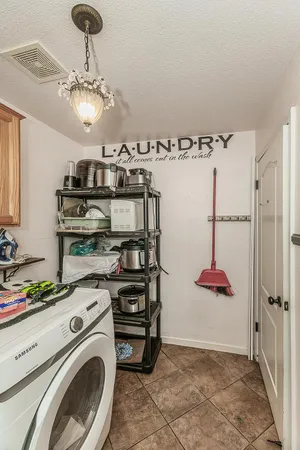a view of an empty room with stairs and a window