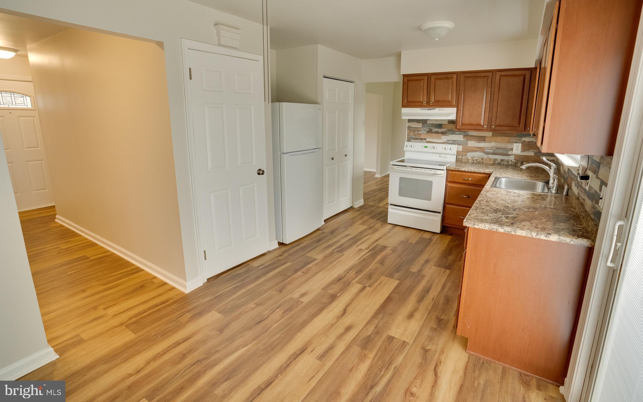 32 Southbridge Road Bear, DE 19701 - Photo 14 of 57 a room with stainless steel appliances wooden floors and wooden cabinets