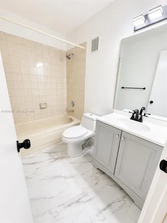 a bathroom with a sink toilet a mirror and shower