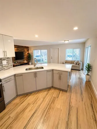 a kitchen with a sink wooden floor and counter top space