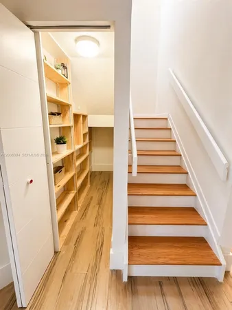 a view of a room with wooden floor and windows