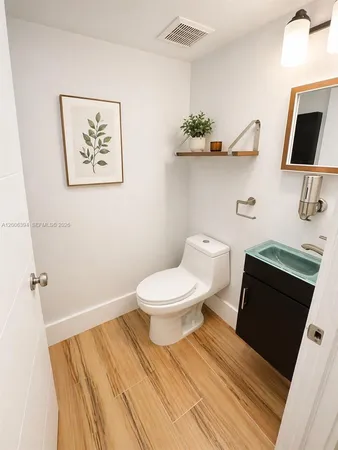 a bathroom with a toilet and a mirror
