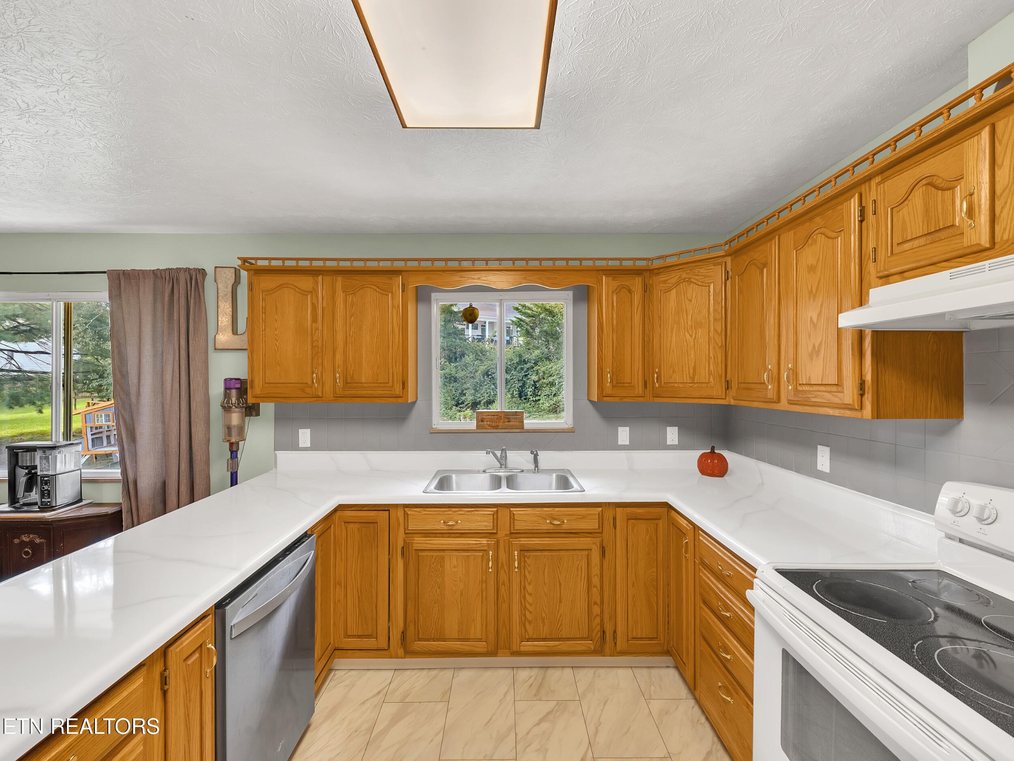 217 Mayview Drive Powell, TN 37849 - Photo 13 of 42 a kitchen with a sink a counter top space and stainless steel appliances