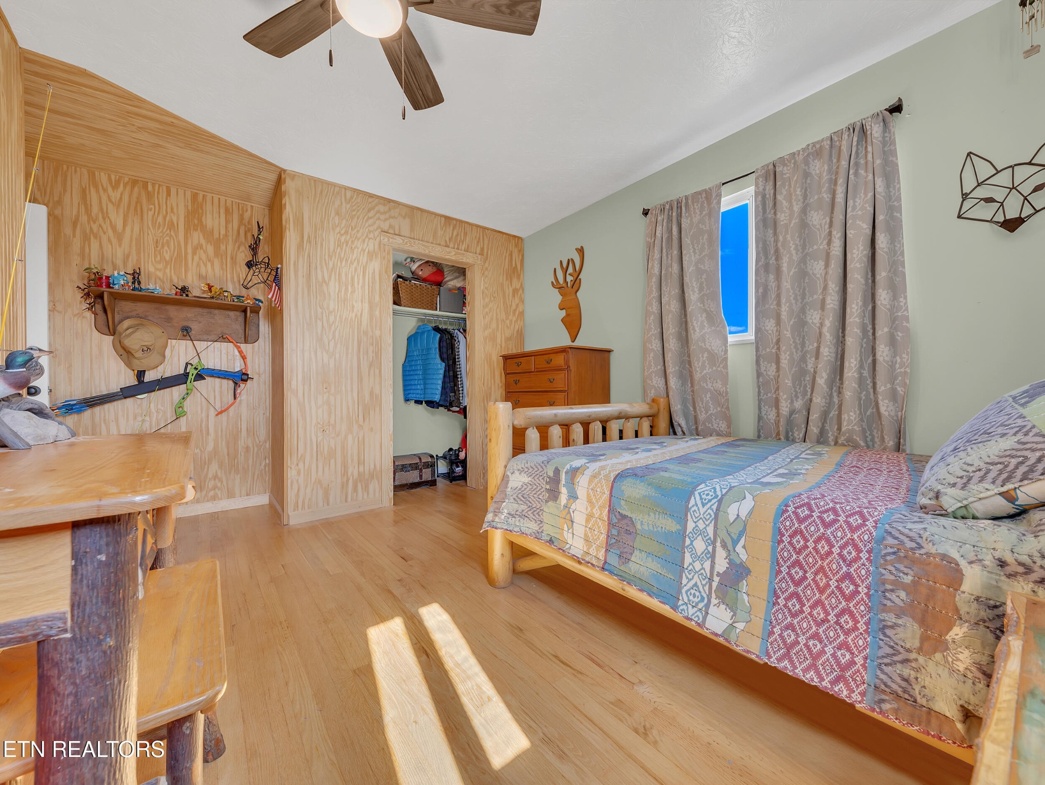 217 Mayview Drive Powell, TN 37849 - Photo 22 of 42 a bedroom with a bed and wooden floor