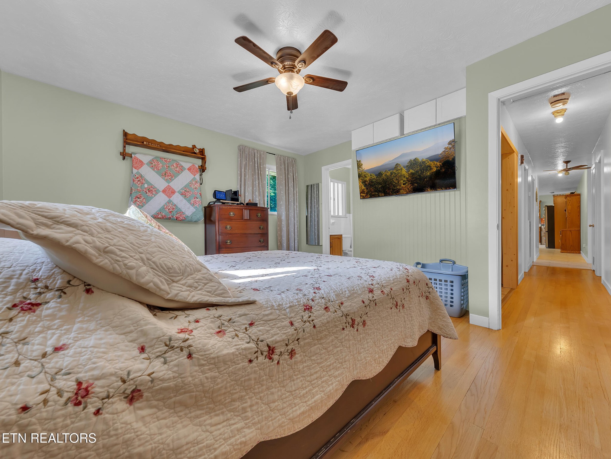 217 Mayview Drive Powell, TN 37849 - Photo 25 of 42 a bedroom with a large bed a flat tv screen and dresser