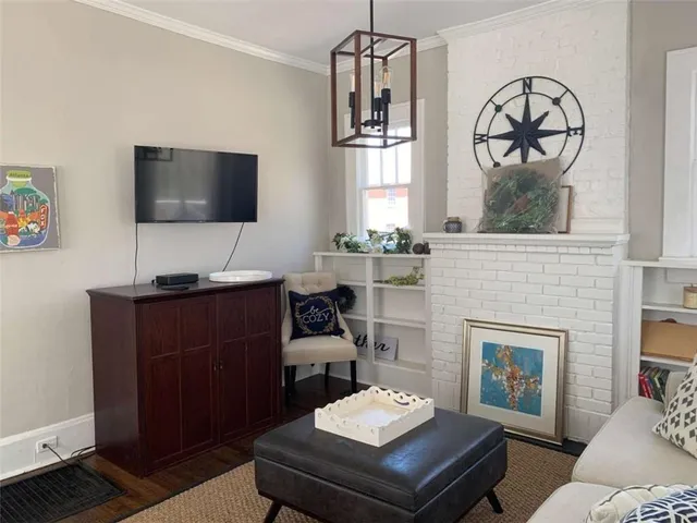 a living room with furniture a flat screen tv and a fireplace