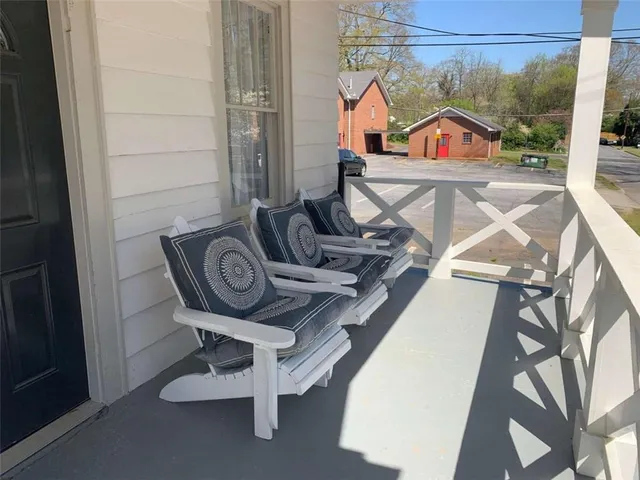 a view of a balcony with table and chairs