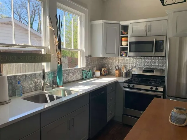 a kitchen with a sink stove and microwave
