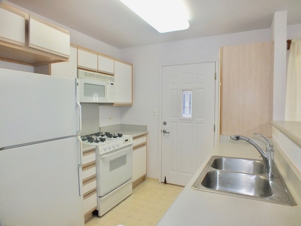 5005 Moi Road Hanapepe, HI 96716 - Photo 3 of 17 a kitchen with white cabinets sink and stove