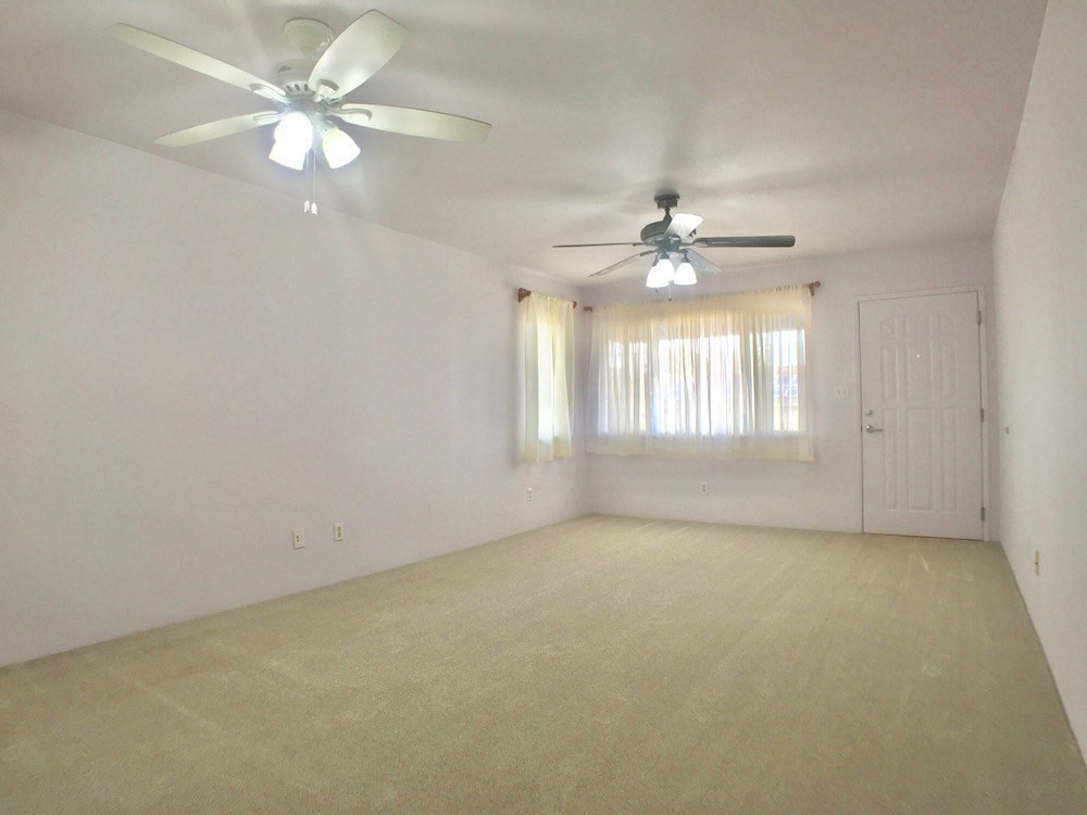 5005 Moi Road Hanapepe, HI 96716 - Photo 5 of 17 an empty room with windows and ceiling fan