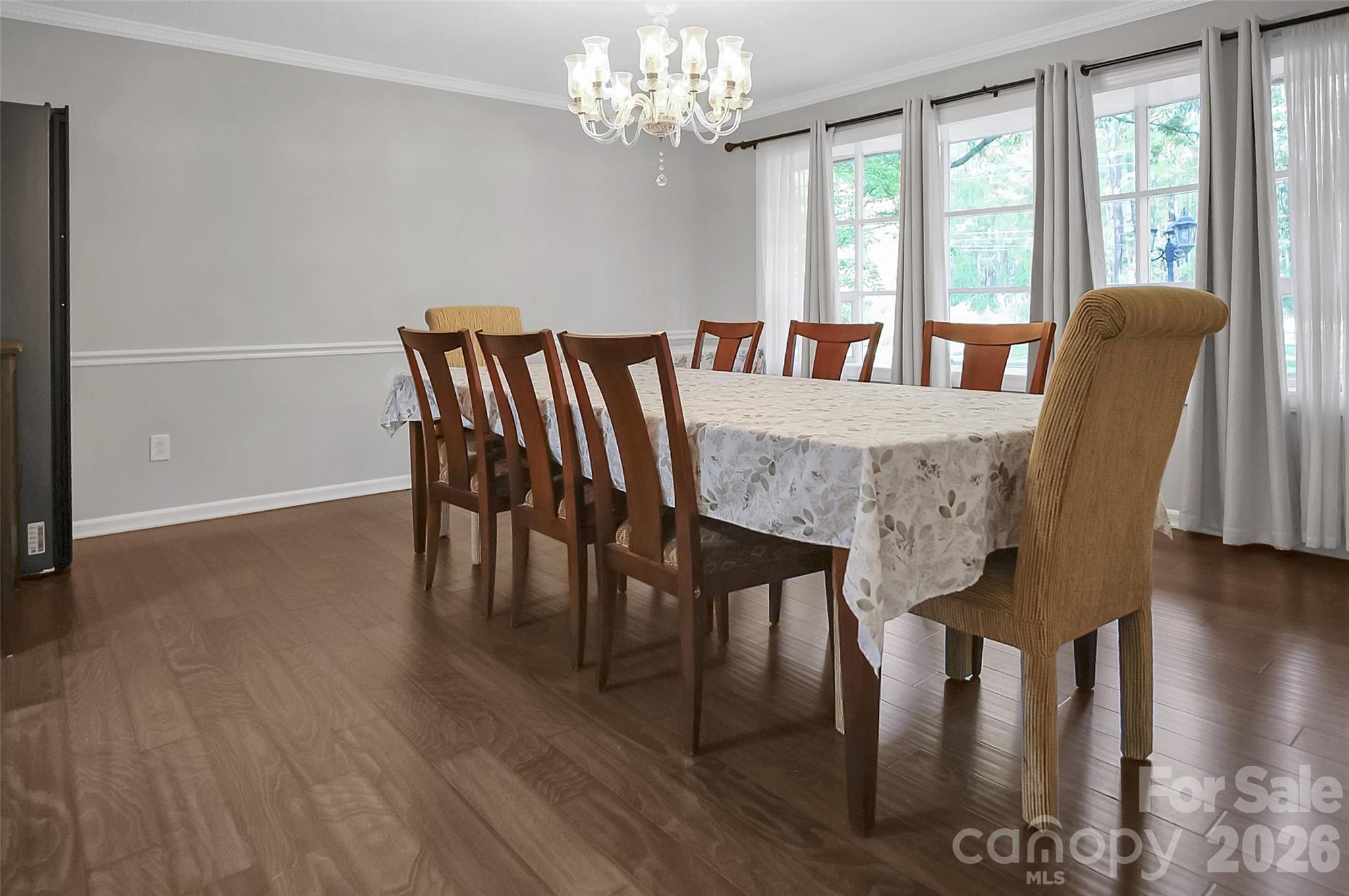 808 Old Mt Holly Road Stanley, NC 28164 - Photo 32 of 48 a view of a dining room with furniture a chandelier and wooden floor