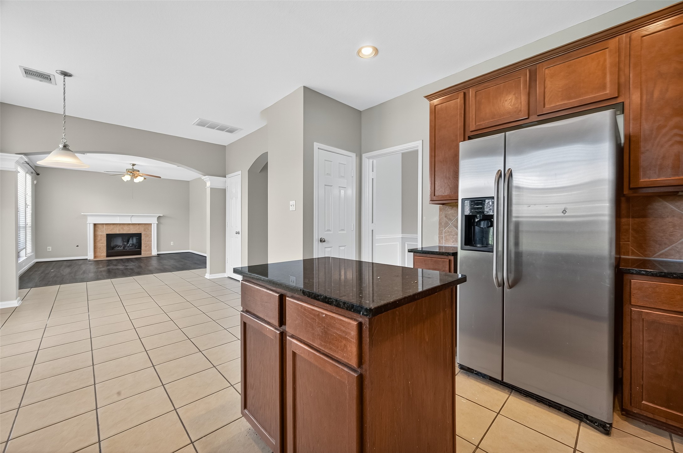 12902 Crystal Reef Court Pearland, TX 77584 - Photo 14 of 35 a kitchen with kitchen island granite countertop a refrigerator and a sink