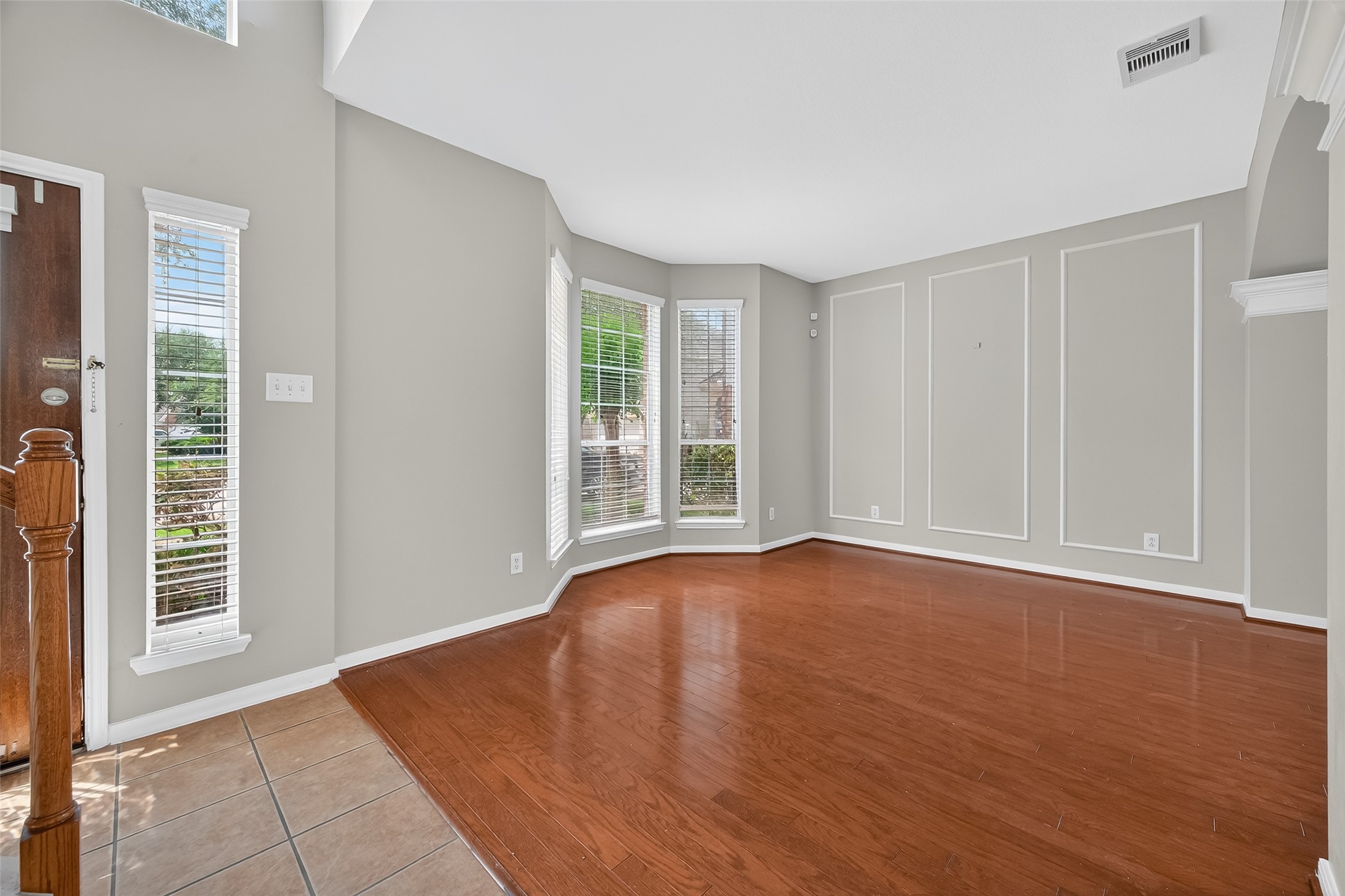 12902 Crystal Reef Court Pearland, TX 77584 - Photo 2 of 35 a view of an empty room with wooden floor and a window