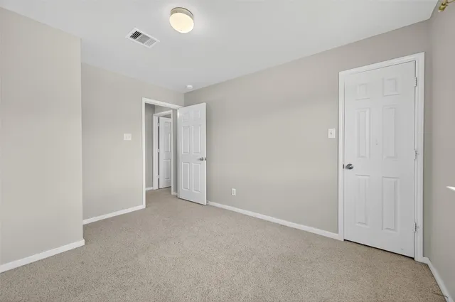 an empty room with closet area