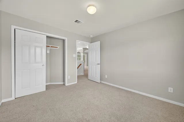 an empty room with closet area