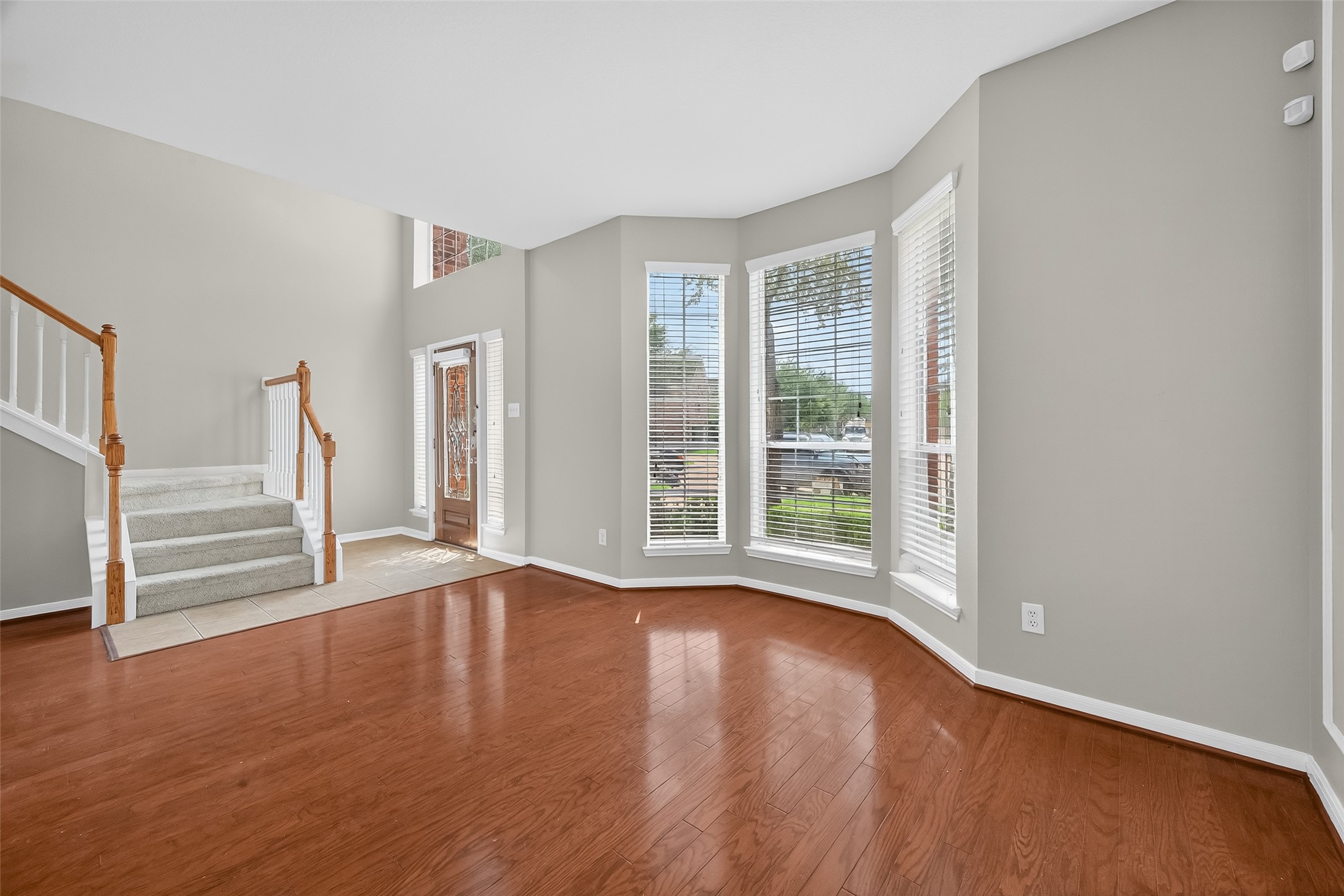 12902 Crystal Reef Court Pearland, TX 77584 - Photo 3 of 35 a view of an empty room with wooden floor and a window
